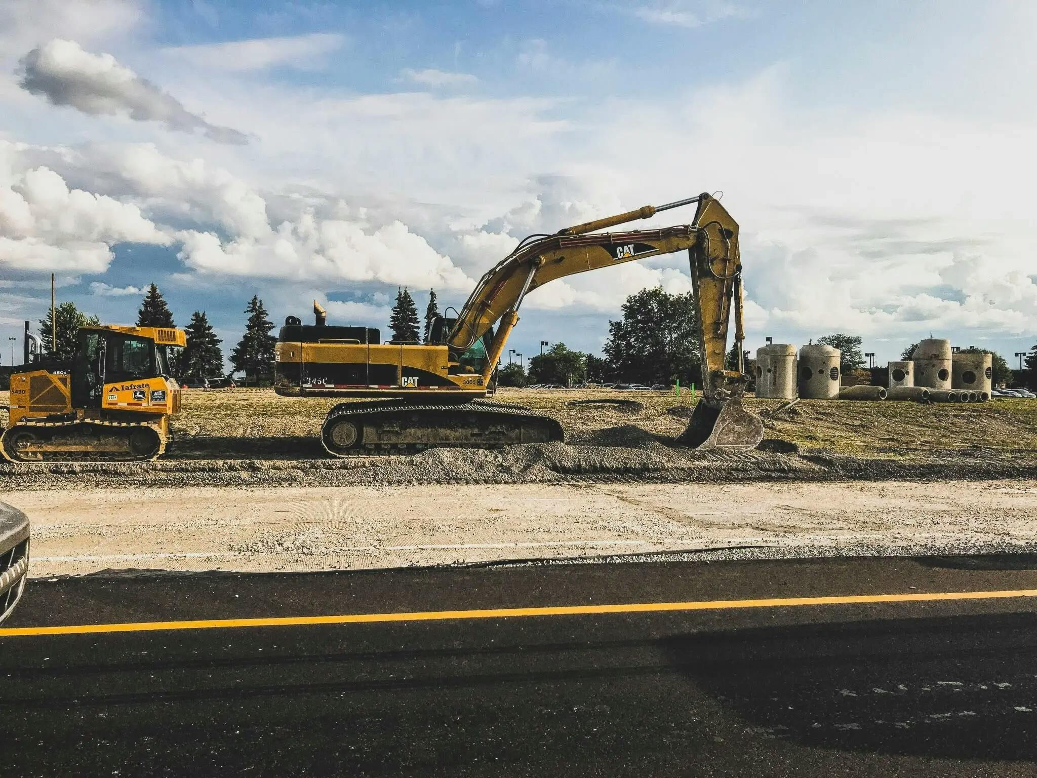 a picture of a road with an excavator