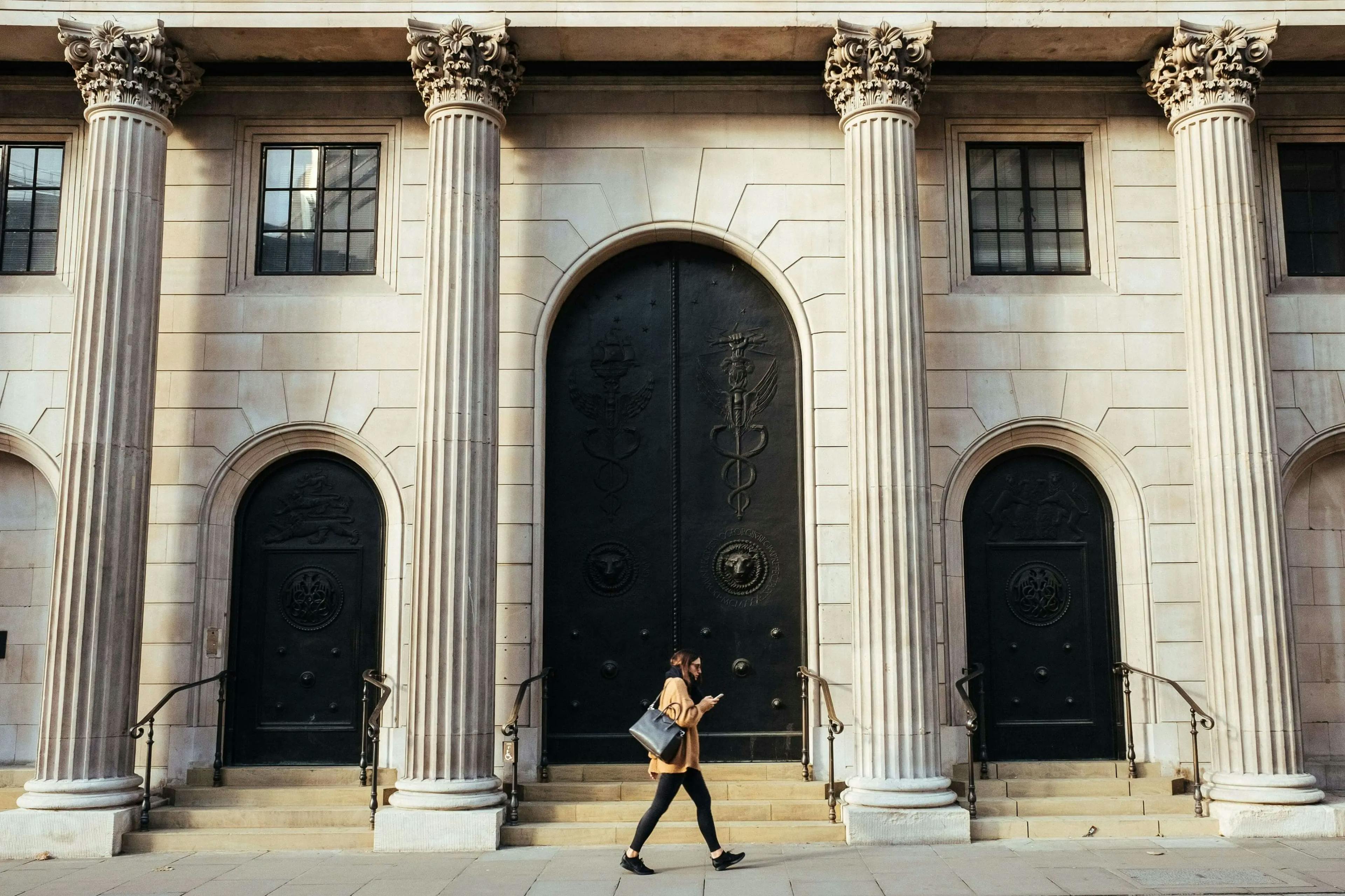 a person walking in front of a bank