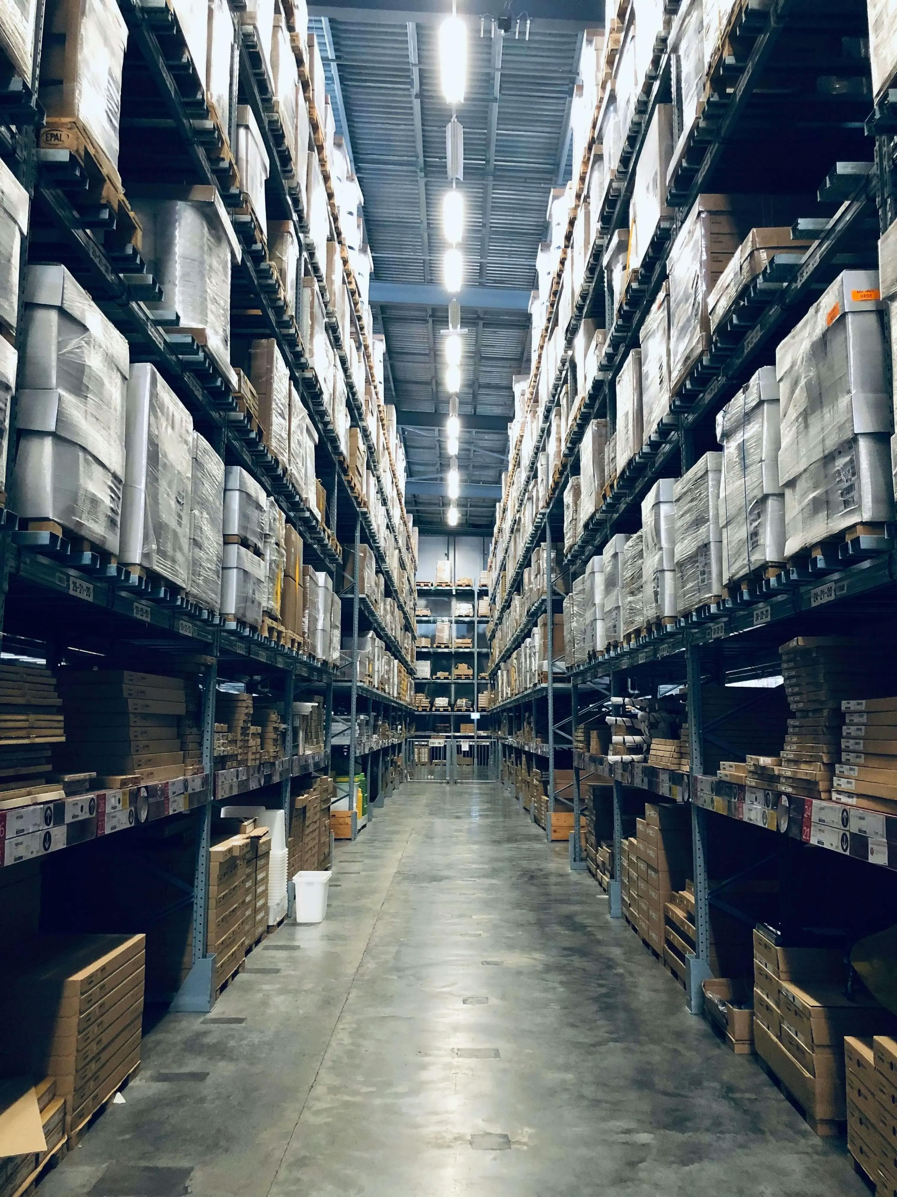 A spacious warehouse filled with numerous shelves and boxes, providing ample storage capacity.